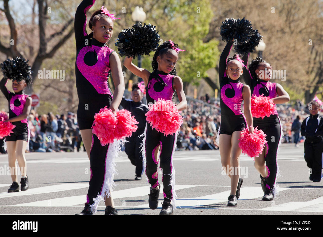 African-American preteen school cheerleaders during parade - USA Stock Photo