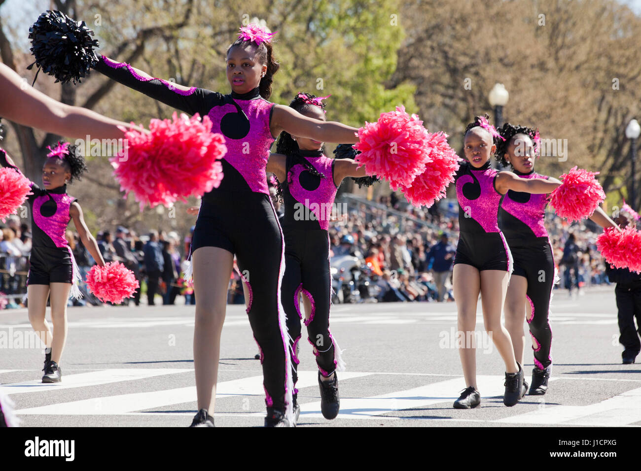 African-American preteen school cheerleaders during parade - USA Stock Photo