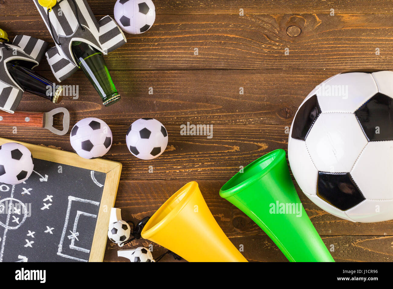Soccer ball and Vuvuzela stadium horns on a wood background Stock Photo