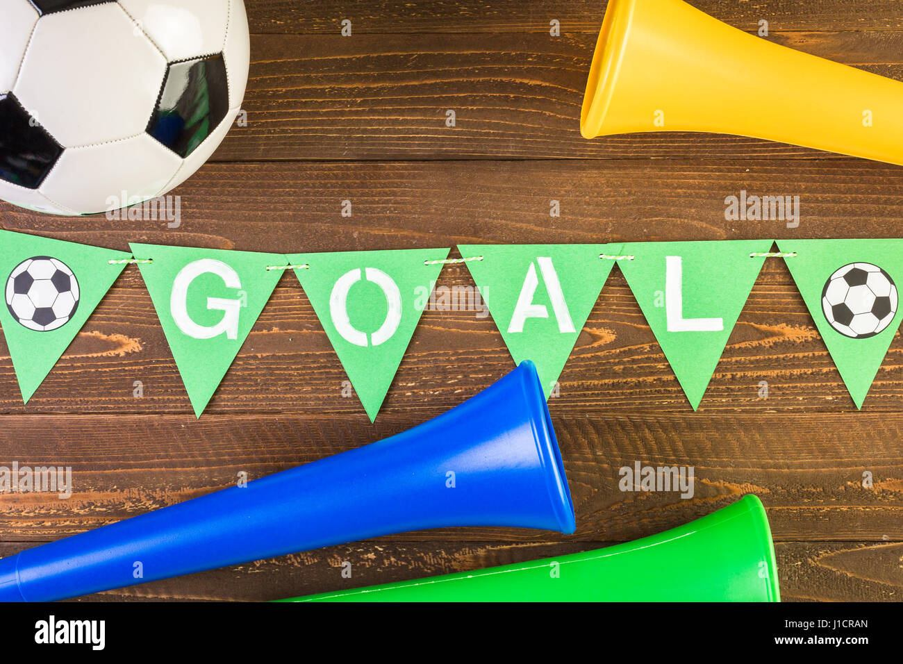 Soccer ball and Vuvuzela stadium horns on a wood background Stock Photo