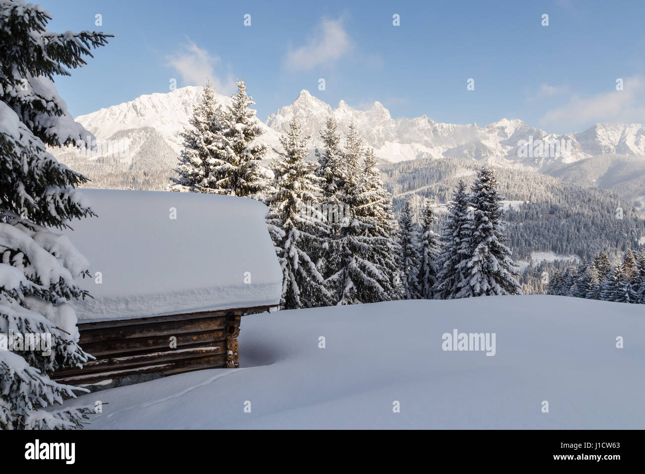 Log Cabin In A Snow Covered Landscape In The Austrian Alps Stock
