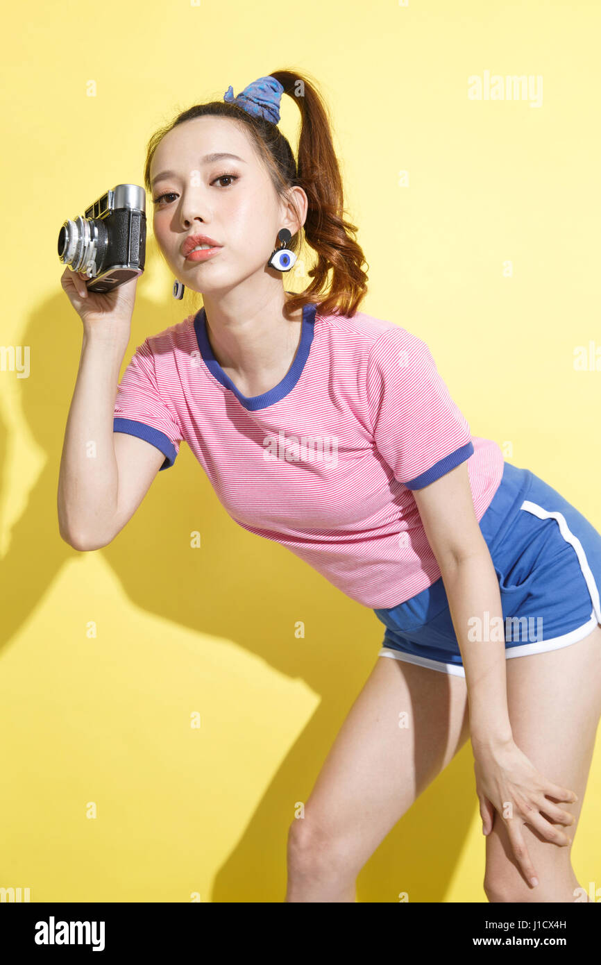 A young woman with a camera. Stock Photo