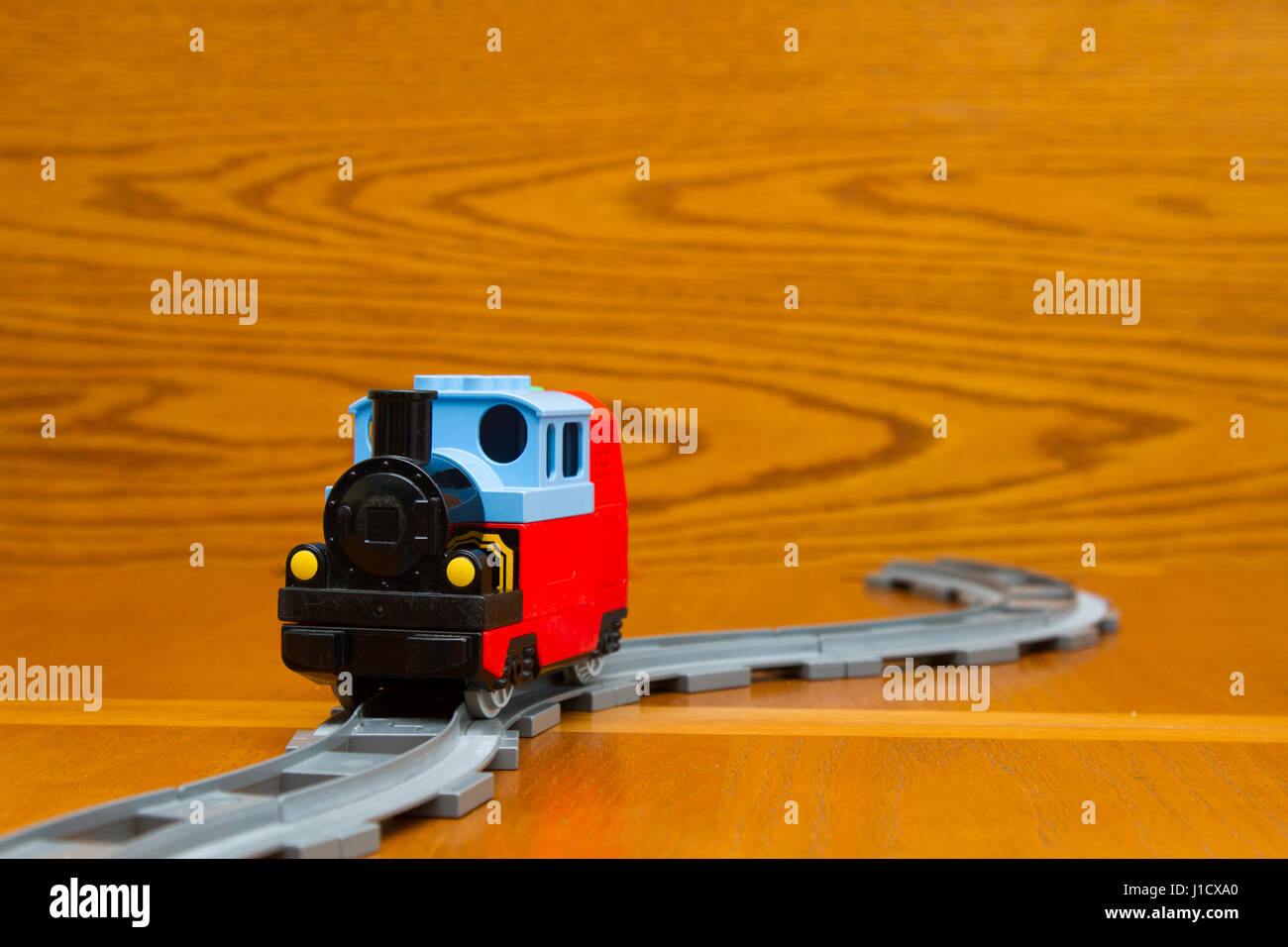 A toy train rides on rails Stock Photo Alamy