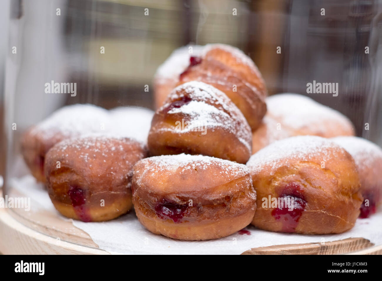 homemade jam doughnuts in a cake dome Stock Photo Alamy