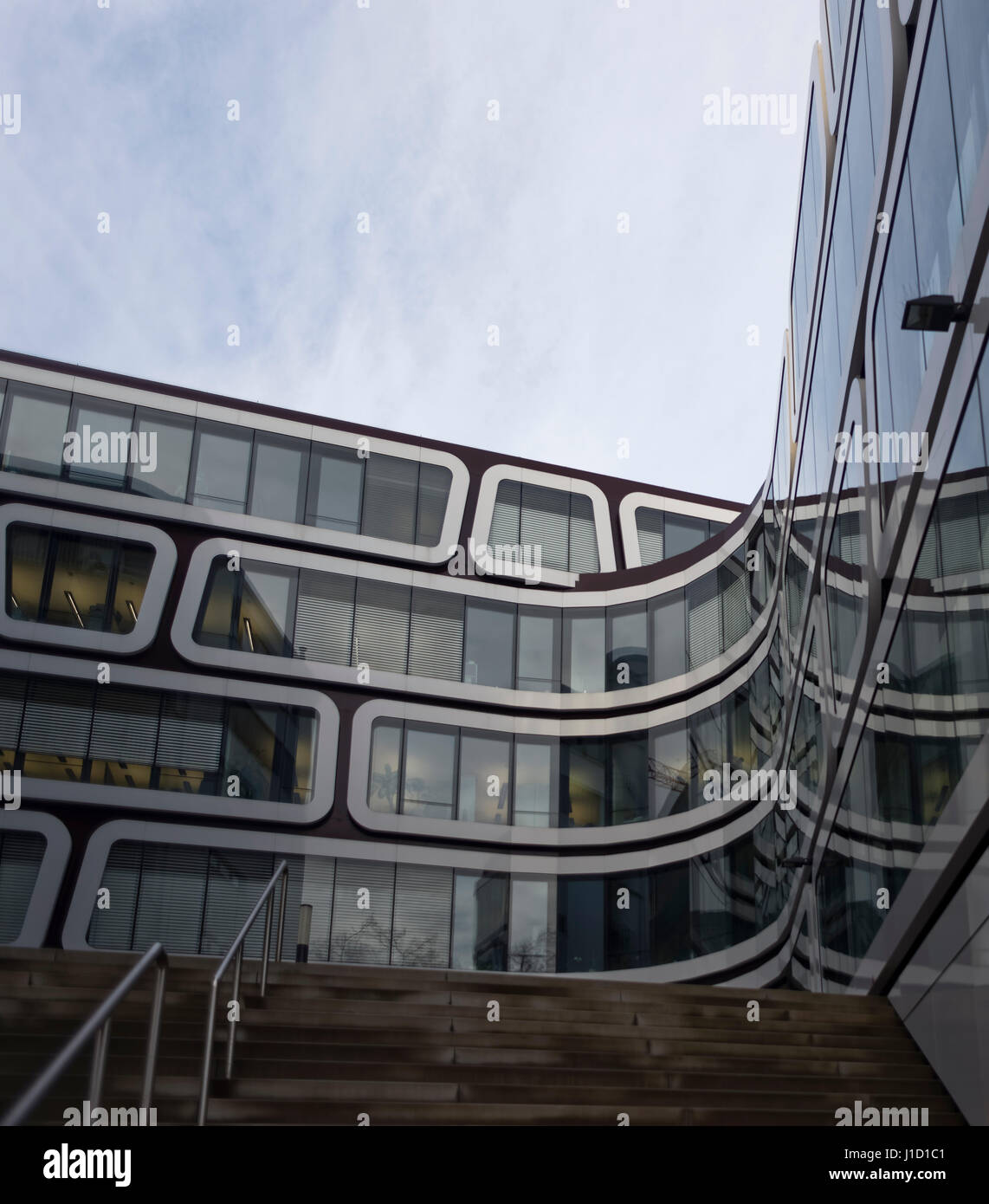 Modern architecture in Stuttgart, Germany. This office building has huge frames around the windows. The building has a z-shape. Stock Photo