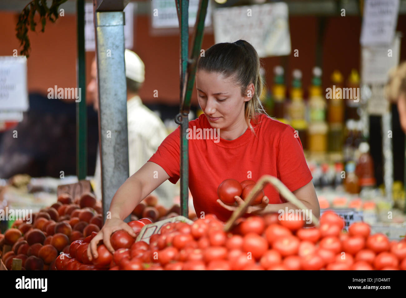 Blonde woman selling tomatoes. Old Bazaar, Skopje, Macedonia Stock Photo