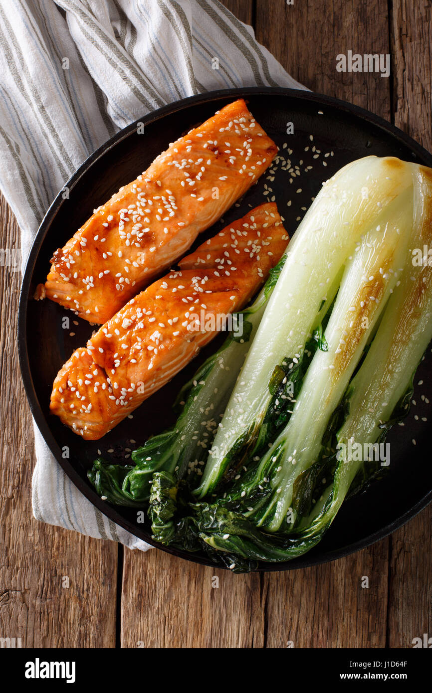 salmon in honeysoy glaze and fried bok choy closeup on a plate