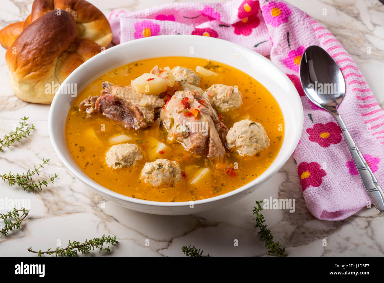 Meat balls soup on table with spoon and bread Stock Photo