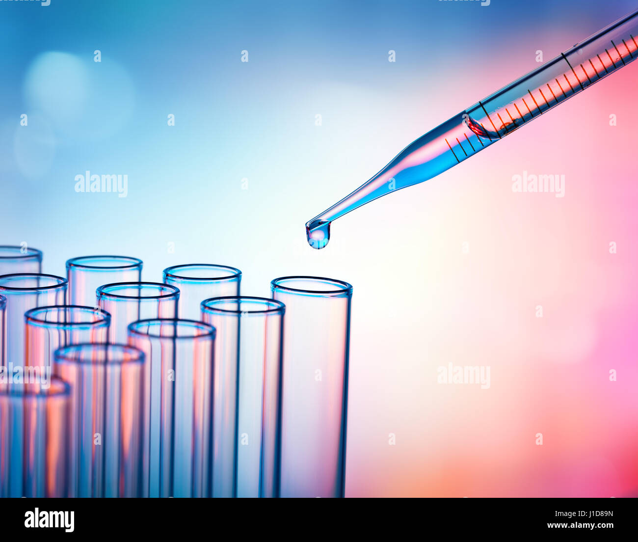 Pipette Dropping A Sample Into A Test Tube - Closeup Stock Photo