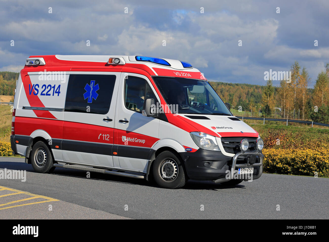 SALO, FINLAND - SEPTEMBER 18, 2016: Ambulance gets an emergency call and rushes ahead along road on a sunny autumn day in South of Finland. Stock Photo