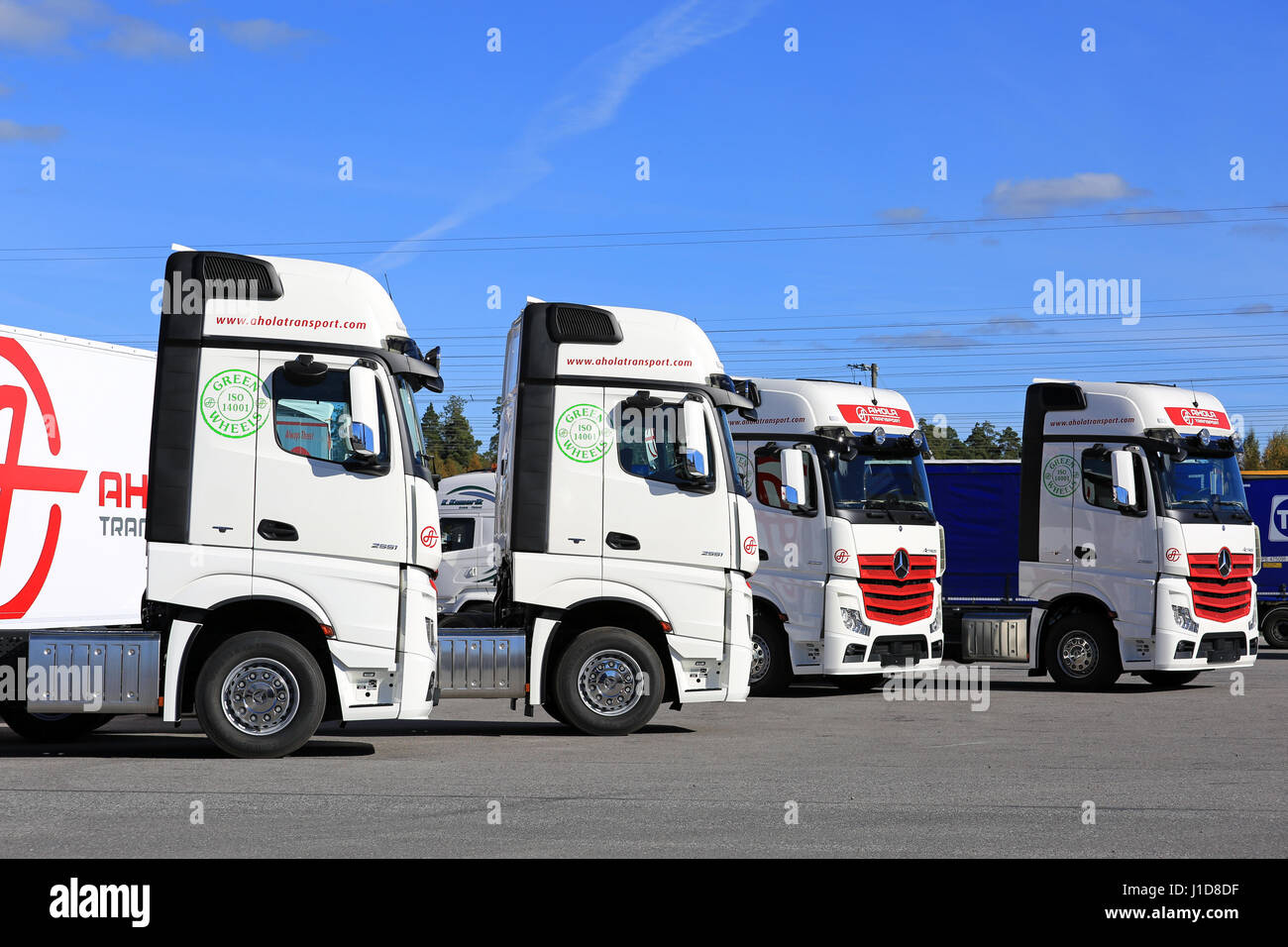 NAANTALI, FINLAND - SEPTEMBER 16; 2016: Fleet of new Mercedes-Benz Actros cargo trucks on display against blue sky on the Open Doors Event of Ahola Tr Stock Photo