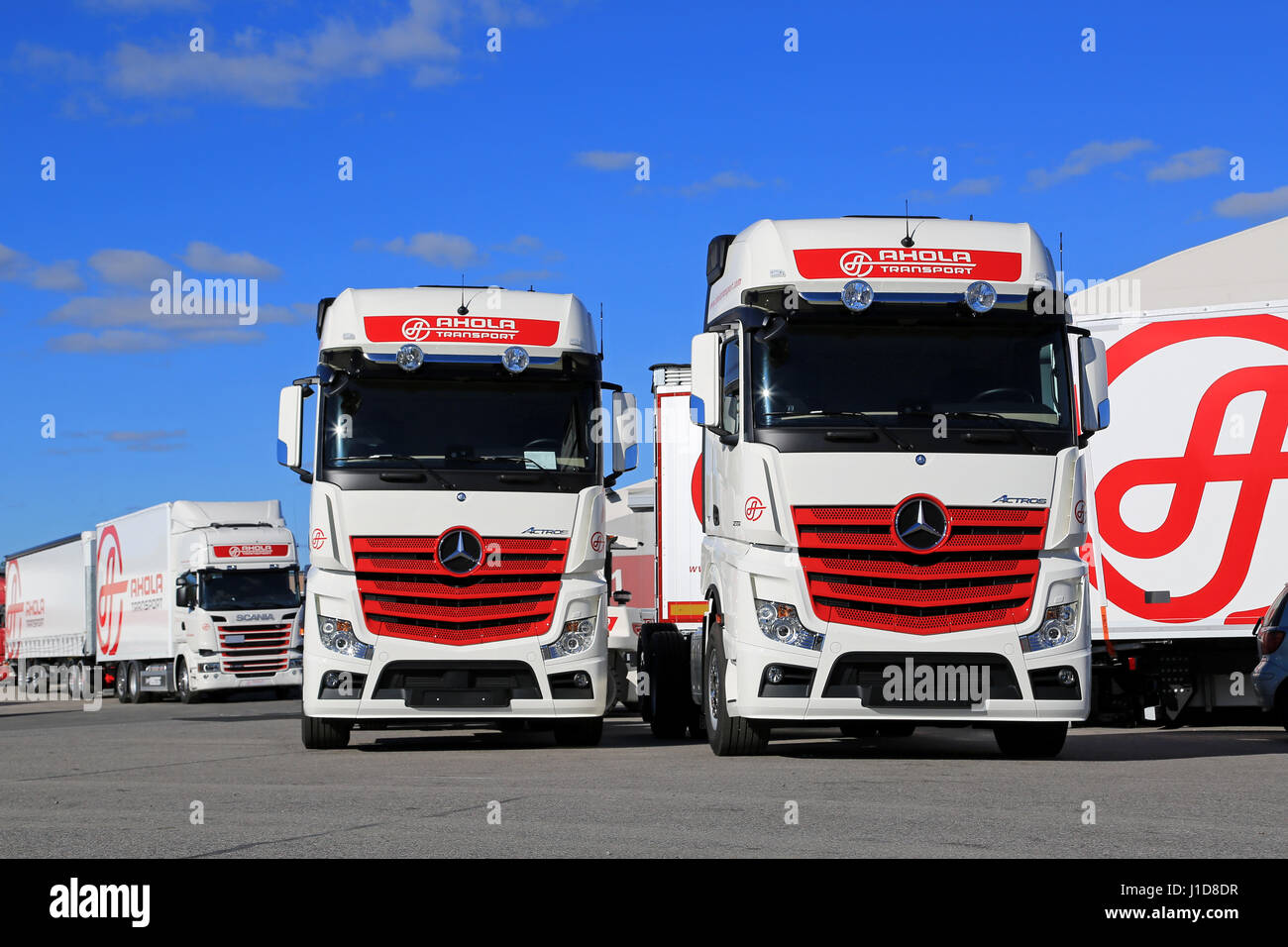 NAANTALI, FINLAND - SEPTEMBER 16; 2016: Fleet of new Mercedes-Benz Actros and Scania cargo trucks on display against blue sky on the Open Doors Event  Stock Photo