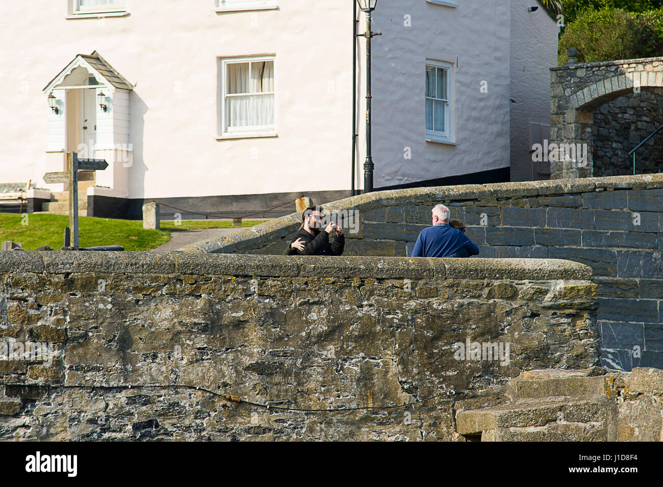 A middle aged couple stops another younger couple and asks for a picture Stock Photo