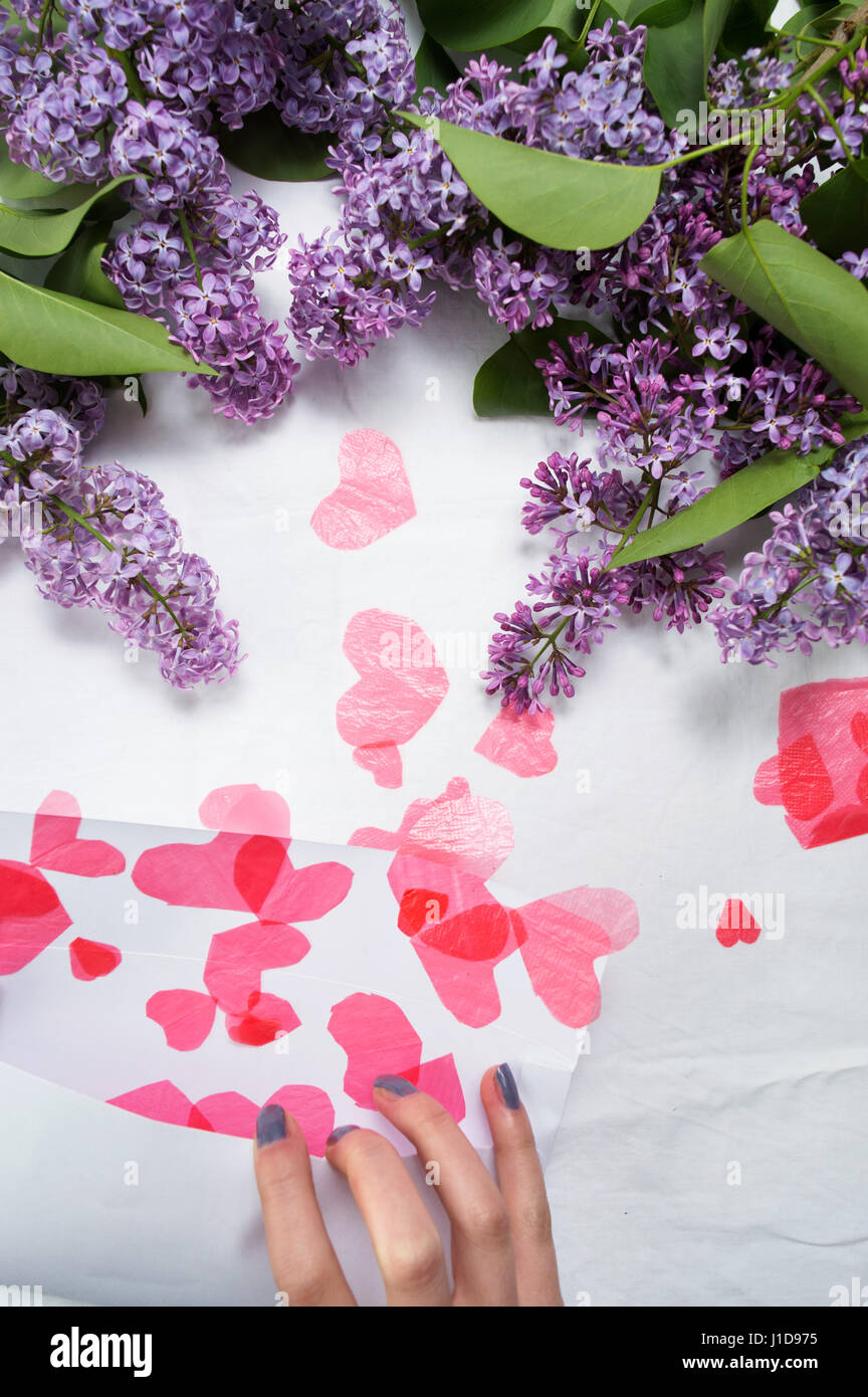 Female opening letter full of red hearts Stock Photo