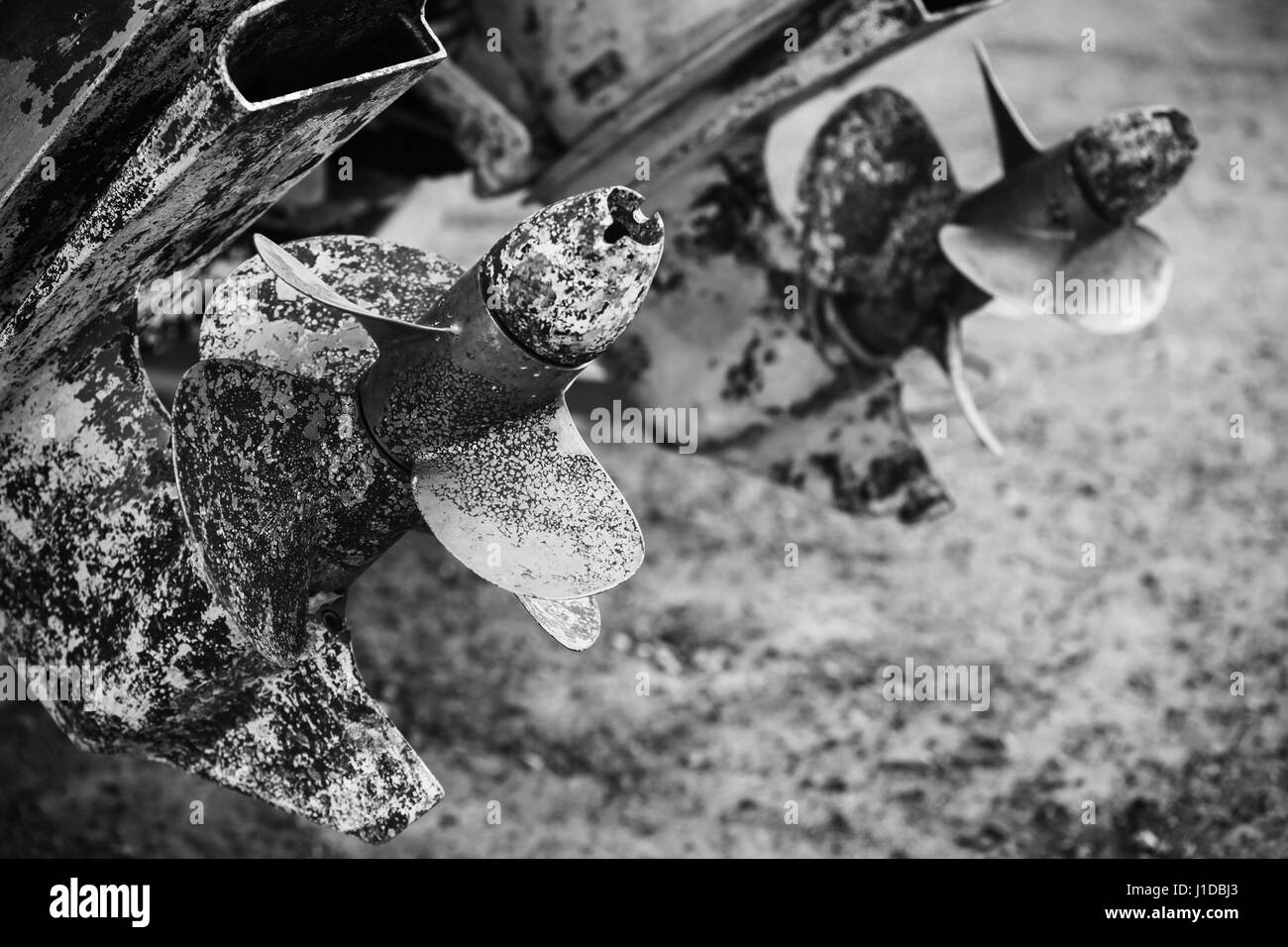 Old rusted propeller screws, grungy black and white photo Stock Photo