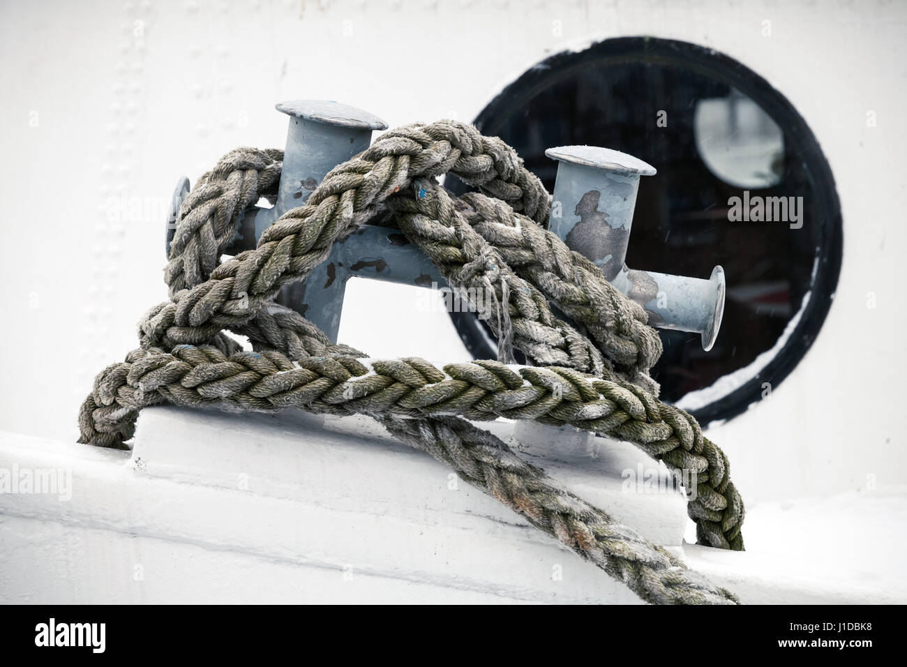 Mooring bollard with rope mounted on old ship deck Stock Photo