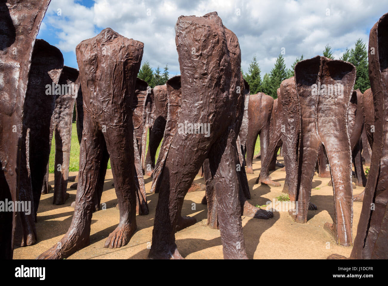 POZNAN, POLAND - AUG 20, 2014: Iron 2 meter tall headless figures marching aimlessly across the Citadel Park in Poznan. The monument is called Unrecog Stock Photo
