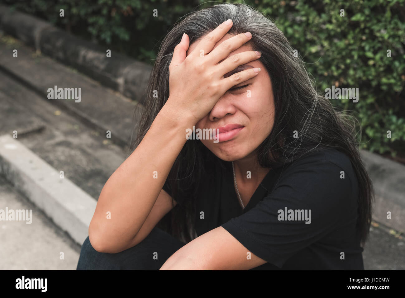 Unemployed woman sitting head in hands Stock Photo Alamy
