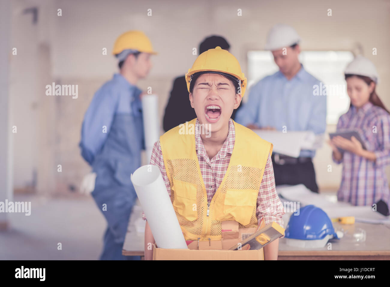 woman fired from job walking and angry over teamwork in construction site building Stock Photo