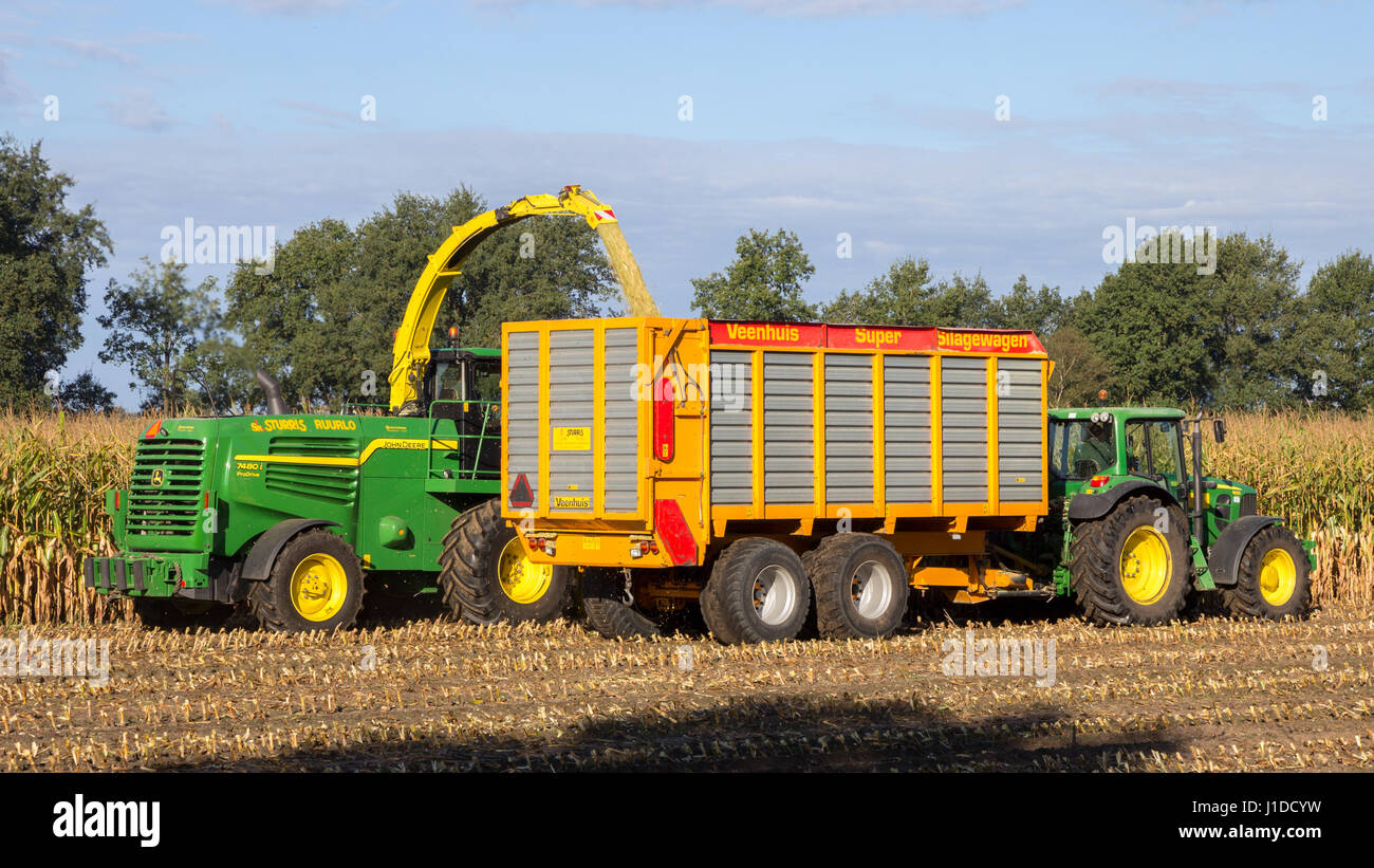 RUURLO, THE NETHERLANDS - SEP 19, 2016: John Deere 6930 tractor and John Deere 7480i Forage Harvester at work. Stock Photo
