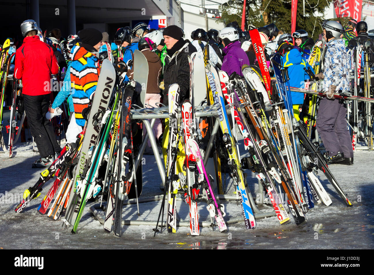 FLACHAU, AUSTRIA - DEC 29, 2012: People at the ski pistes in the ski resort town of Flachau in the Austrian Alps. These pistes are part of the Ski Arm Stock Photo