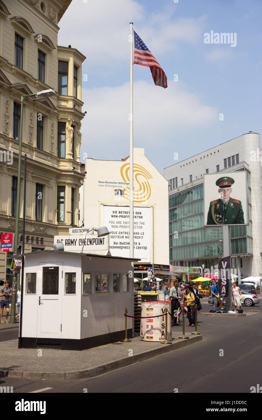 BERLIN, GERMANY - MAY 23, 2014: Tourists around the former Allied Checkpoint Charlie. Nowadays this site is a tourist attraction. Stock Photo
