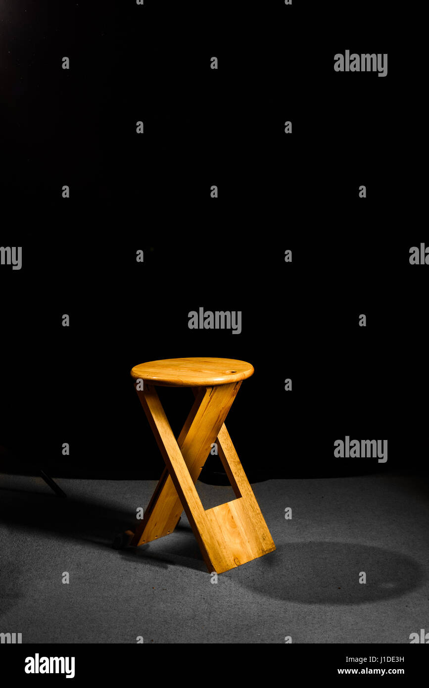 Solitary wooden folding stool Stock Photo