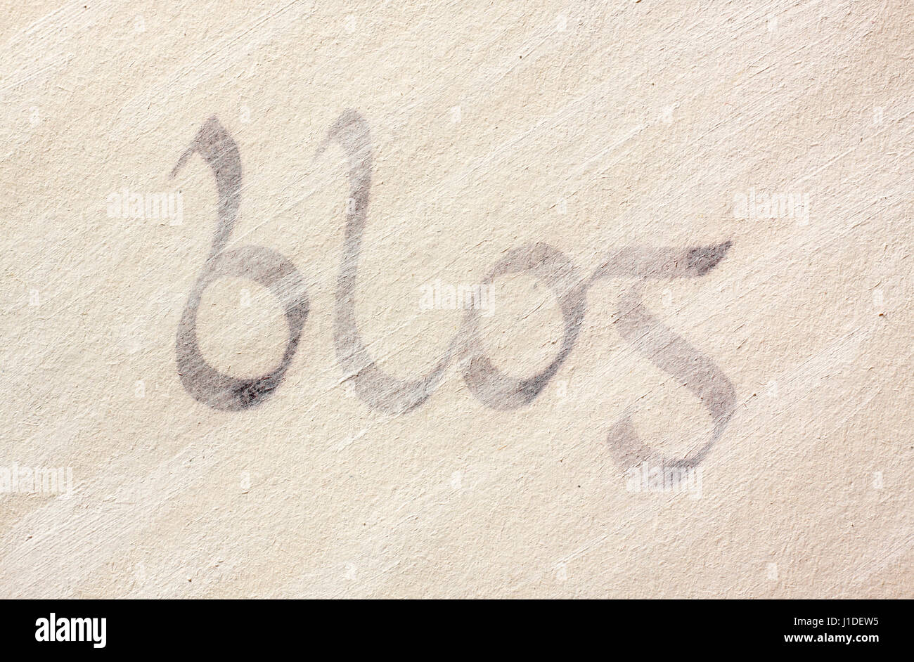 The word Blog handwriting with use of gaelic (celtic, insular) typeface under coat of a white paint layer Stock Photo