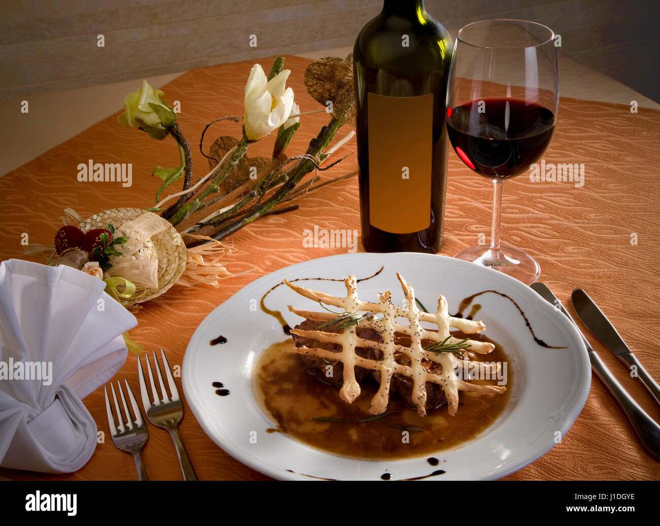 Fine gourmet dinner with a glass and a bottle of red wine Stock Photo -  Alamy