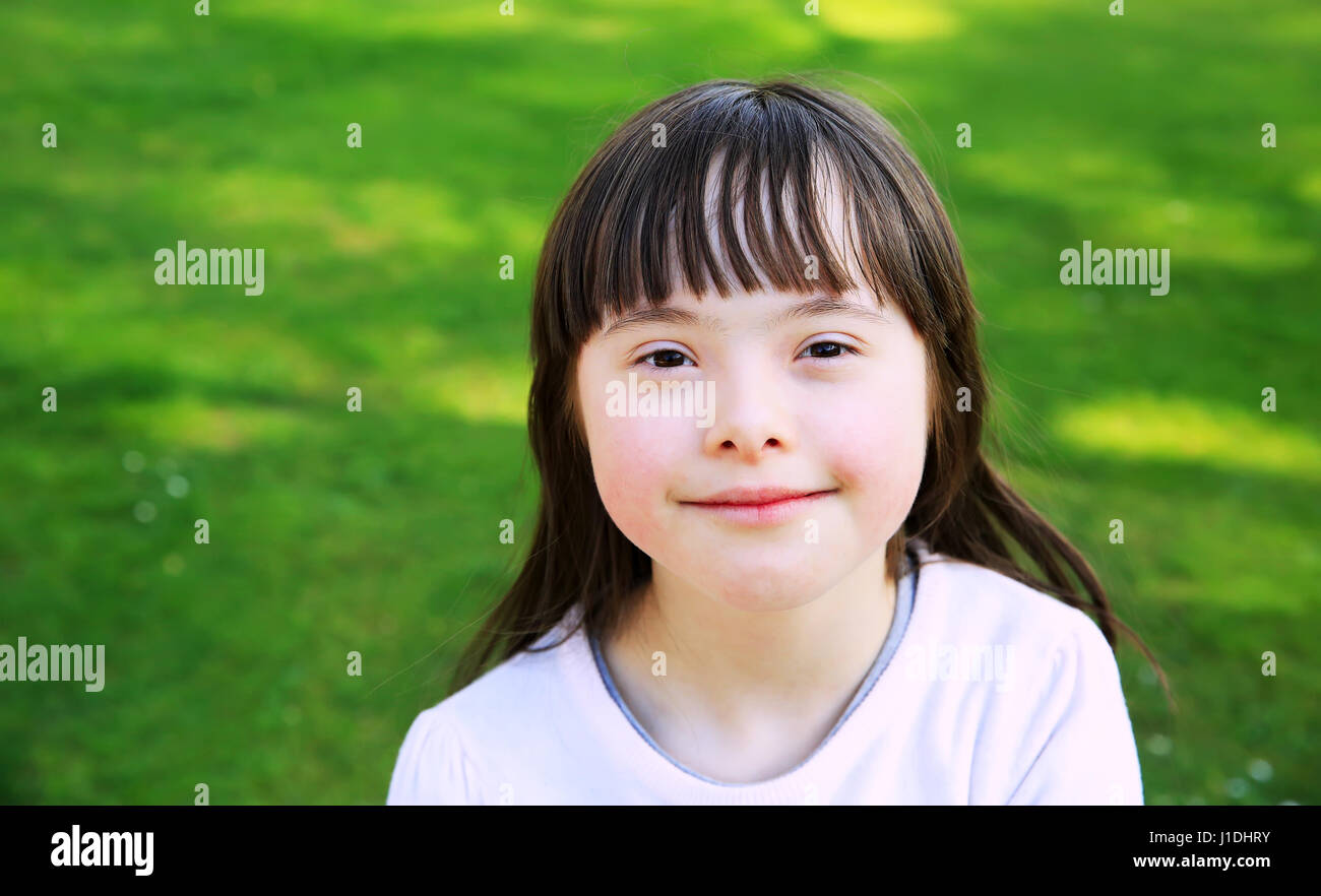 Portrait of little girl smiling outside Stock Photo - Alamy