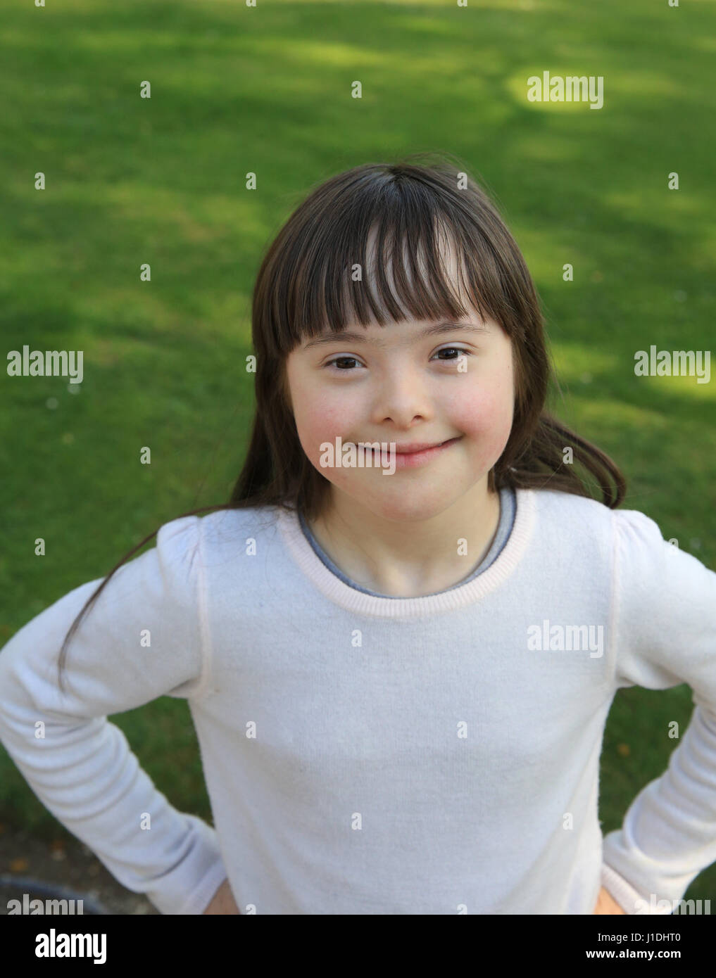 Portrait of little girl smiling outside Stock Photo - Alamy