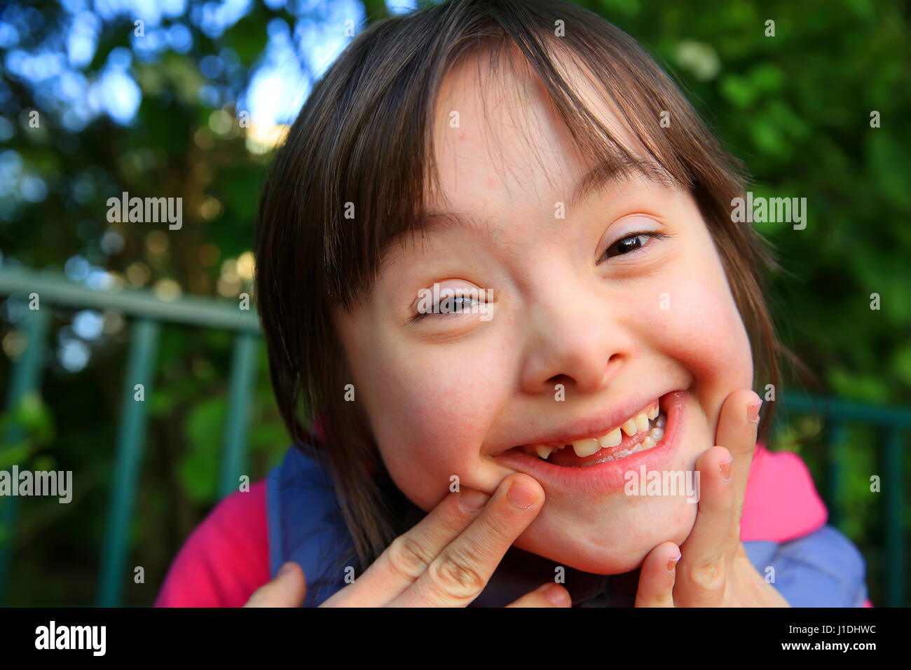 Portrait of little girl smiling outside Stock Photo - Alamy