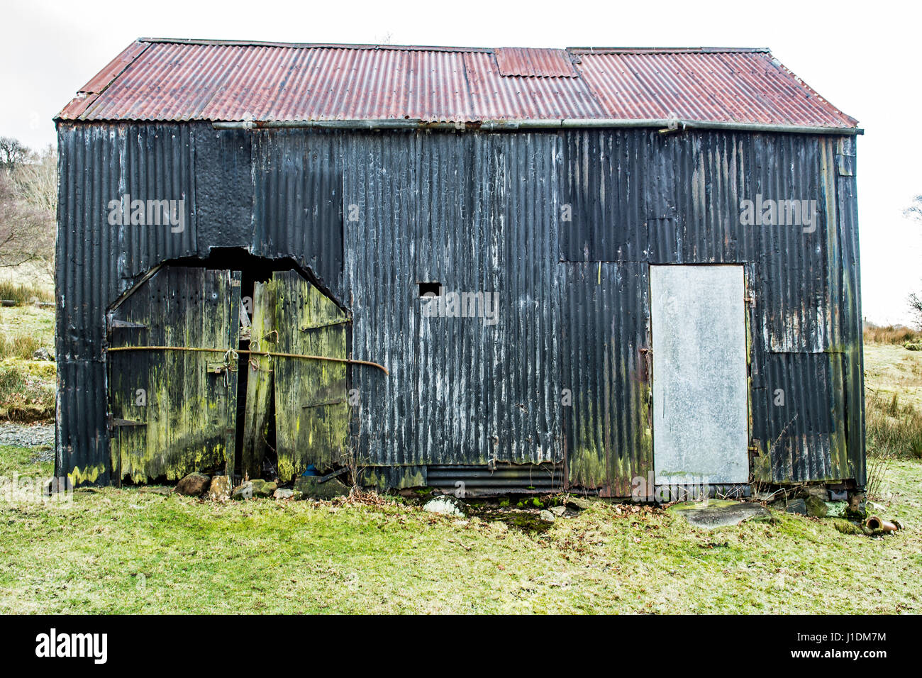 Old dilapidated corrugated metal barn in the welsh hills. Stock Photo