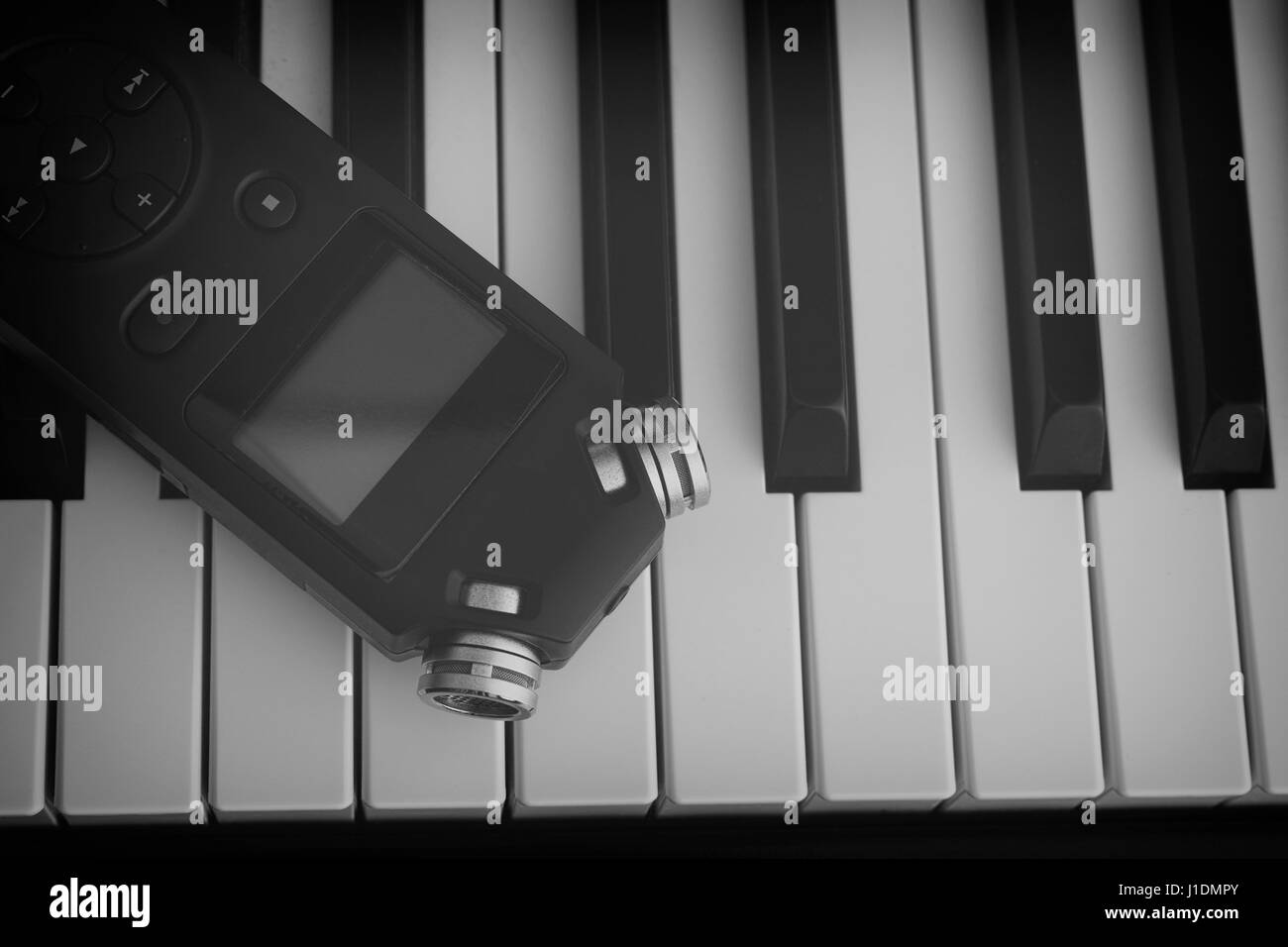 Piano and audio recorder. Black and White. Close up. Stock Photo