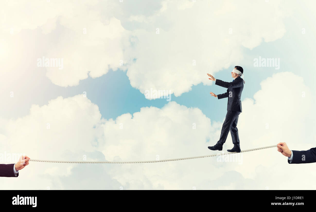 Business concept of risk support and assistance with man balancing on ...