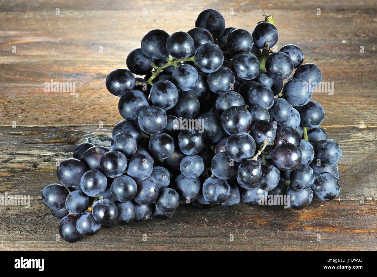 grapes (variety Muscat Bleu) on wooden background Stock Photo
