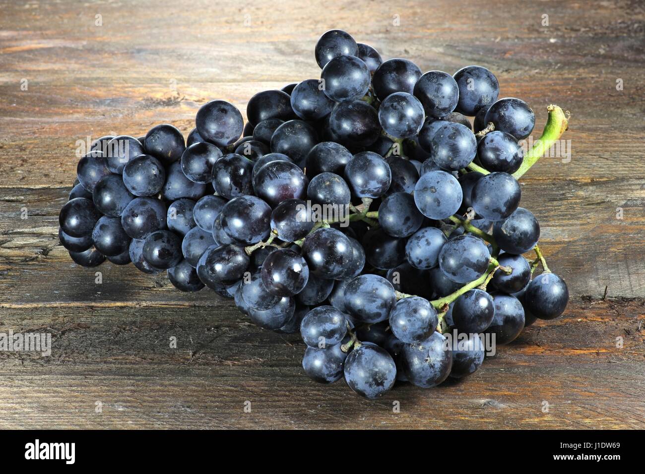 grapes (variety Muscat Bleu) on wooden background Stock Photo