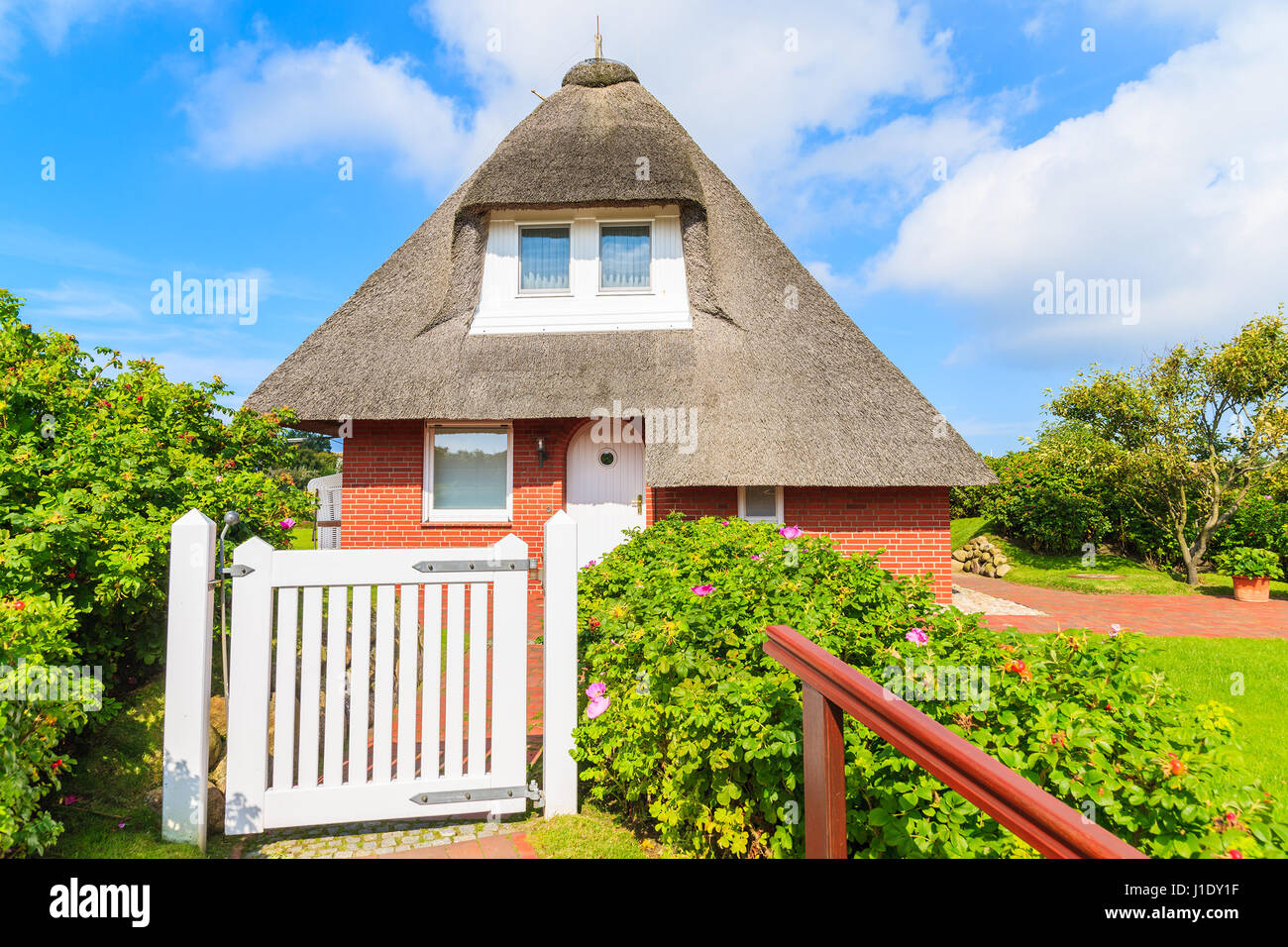 Typical red brick house in Westerheide village with straw roof, Sylt island, Germany Stock Photo
