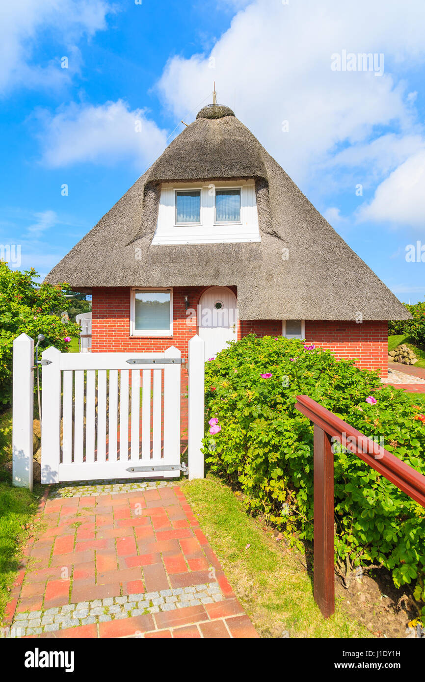 Typical red brick house in Westerheide village with straw roof, Sylt