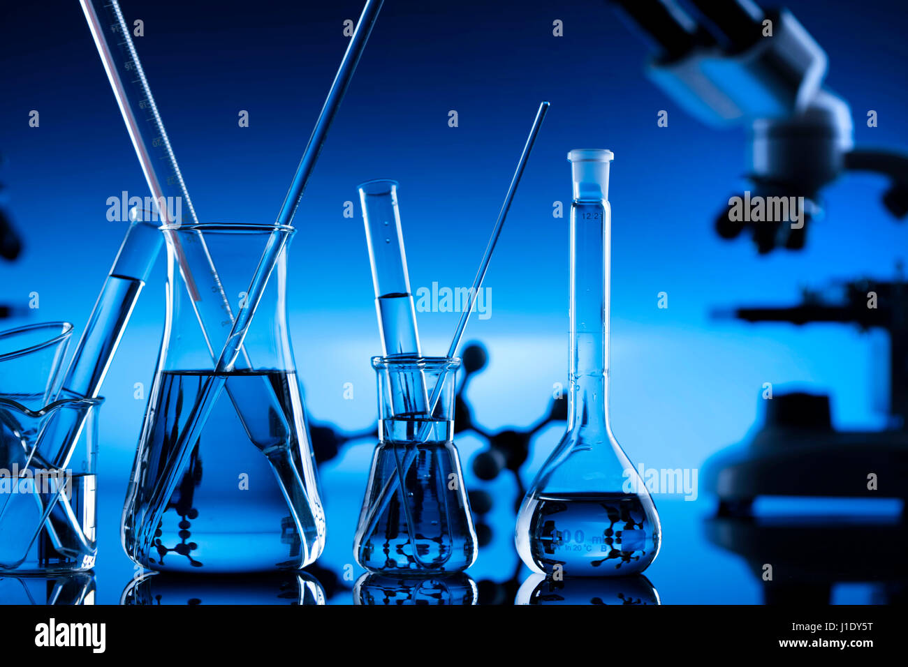 Modern laboratory equipment , set of different glassware on blue ...