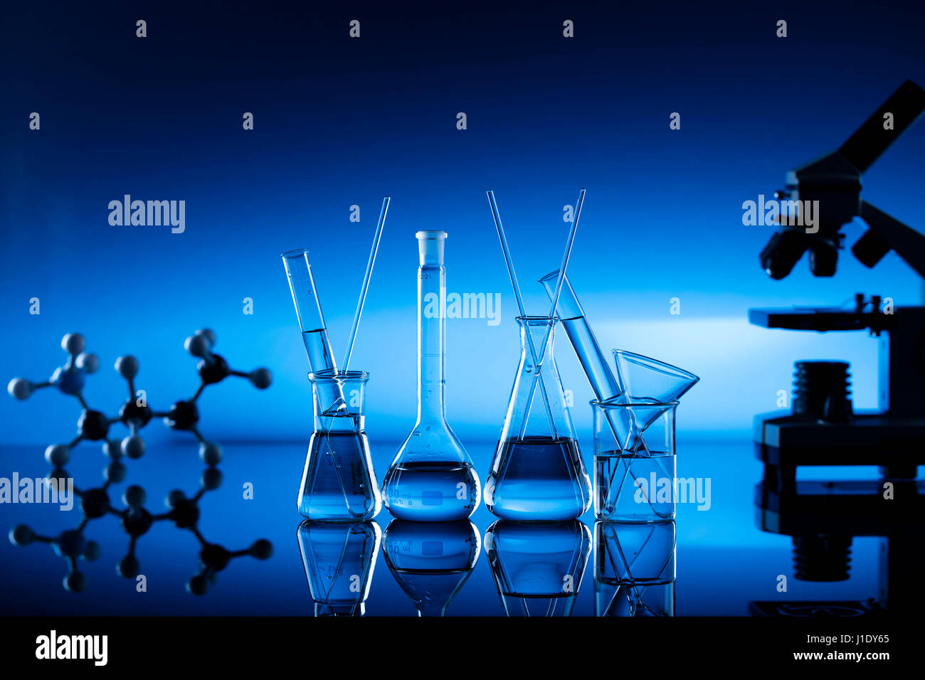 Modern laboratory equipment , set of different glassware on blue ...