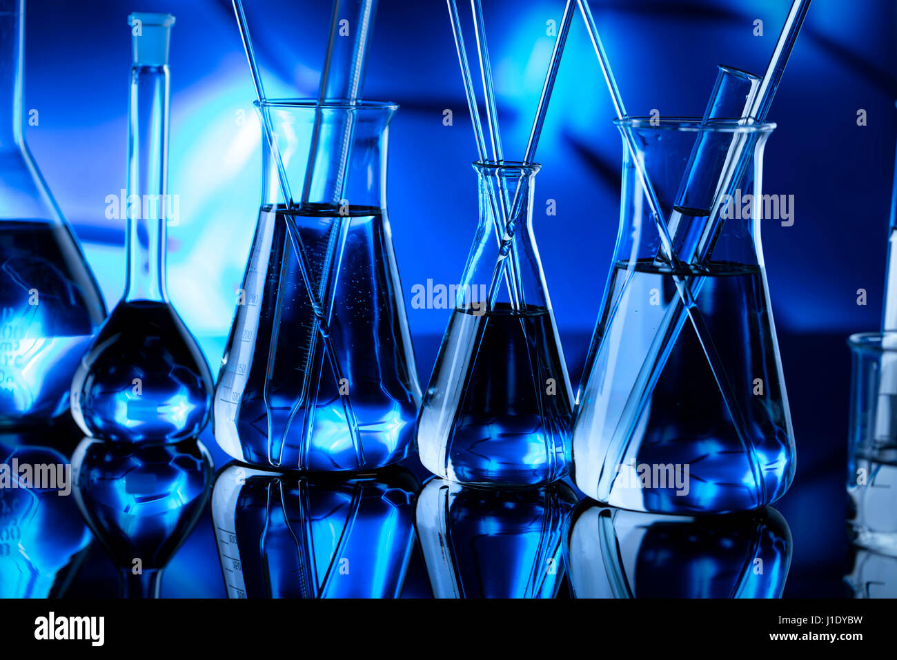 Modern laboratory equipment , set of different glassware on blue ...