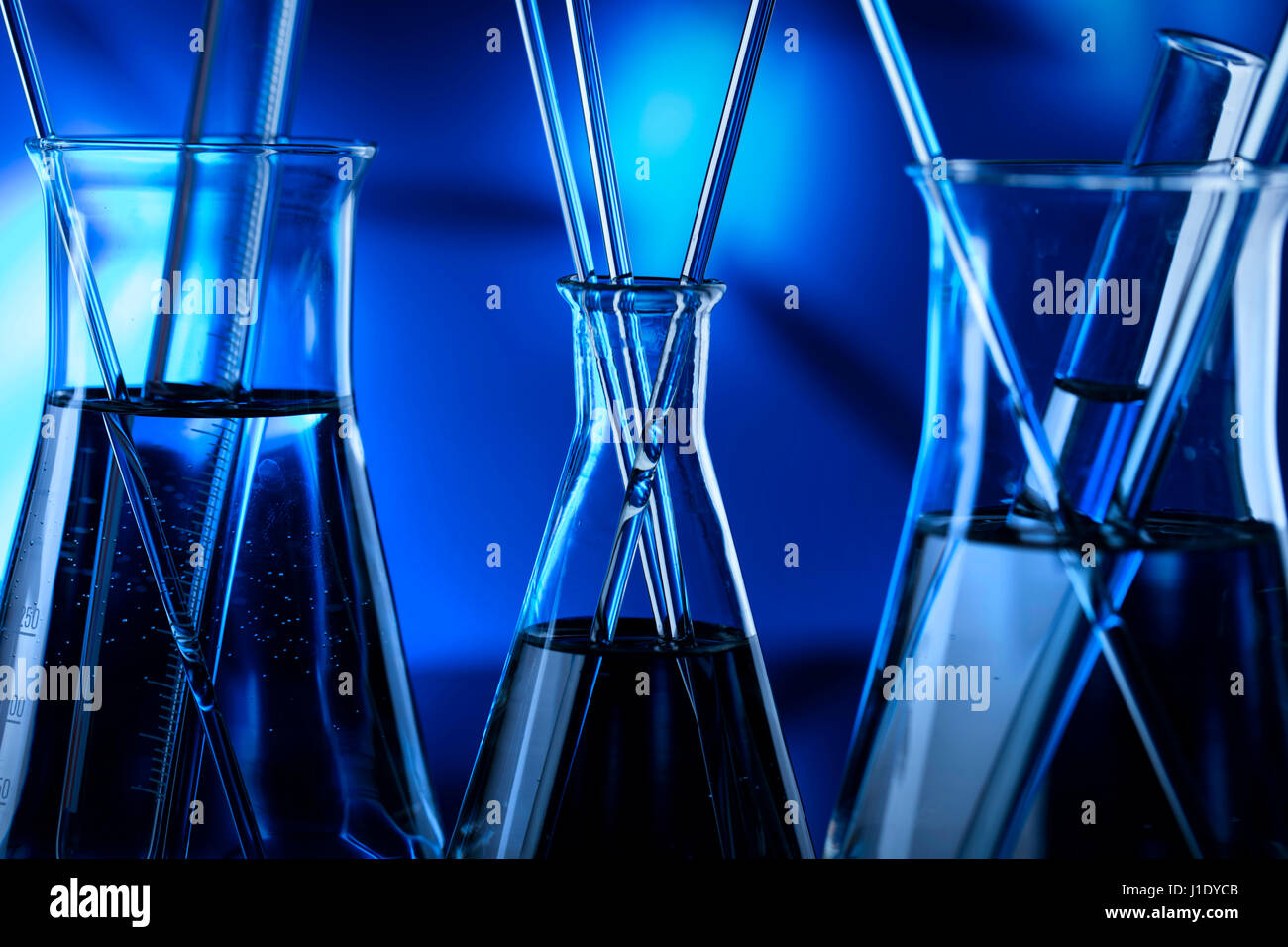 Modern laboratory equipment , set of different glassware on blue ...