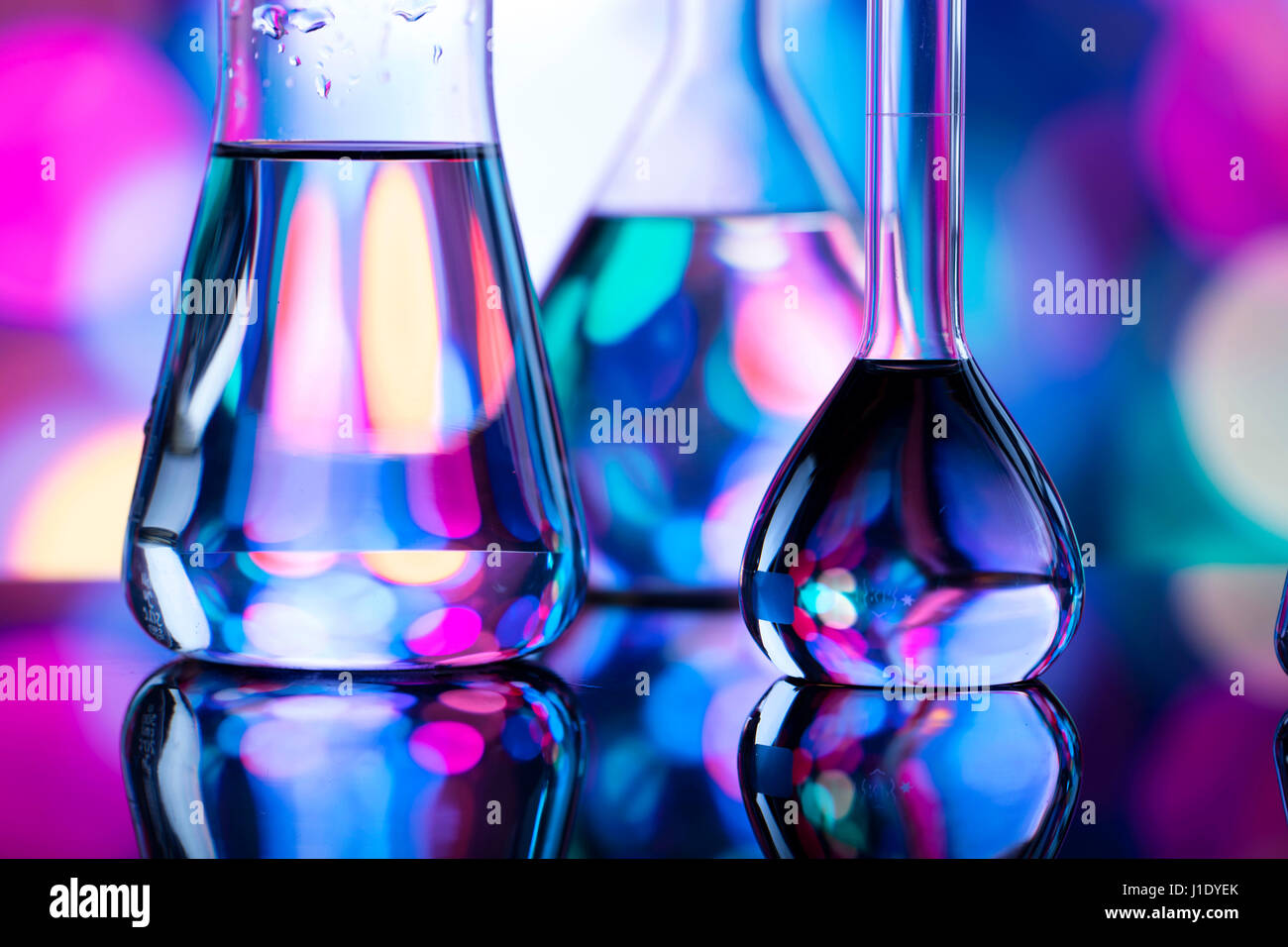 Modern laboratory equipment , set of different glassware on blue ...