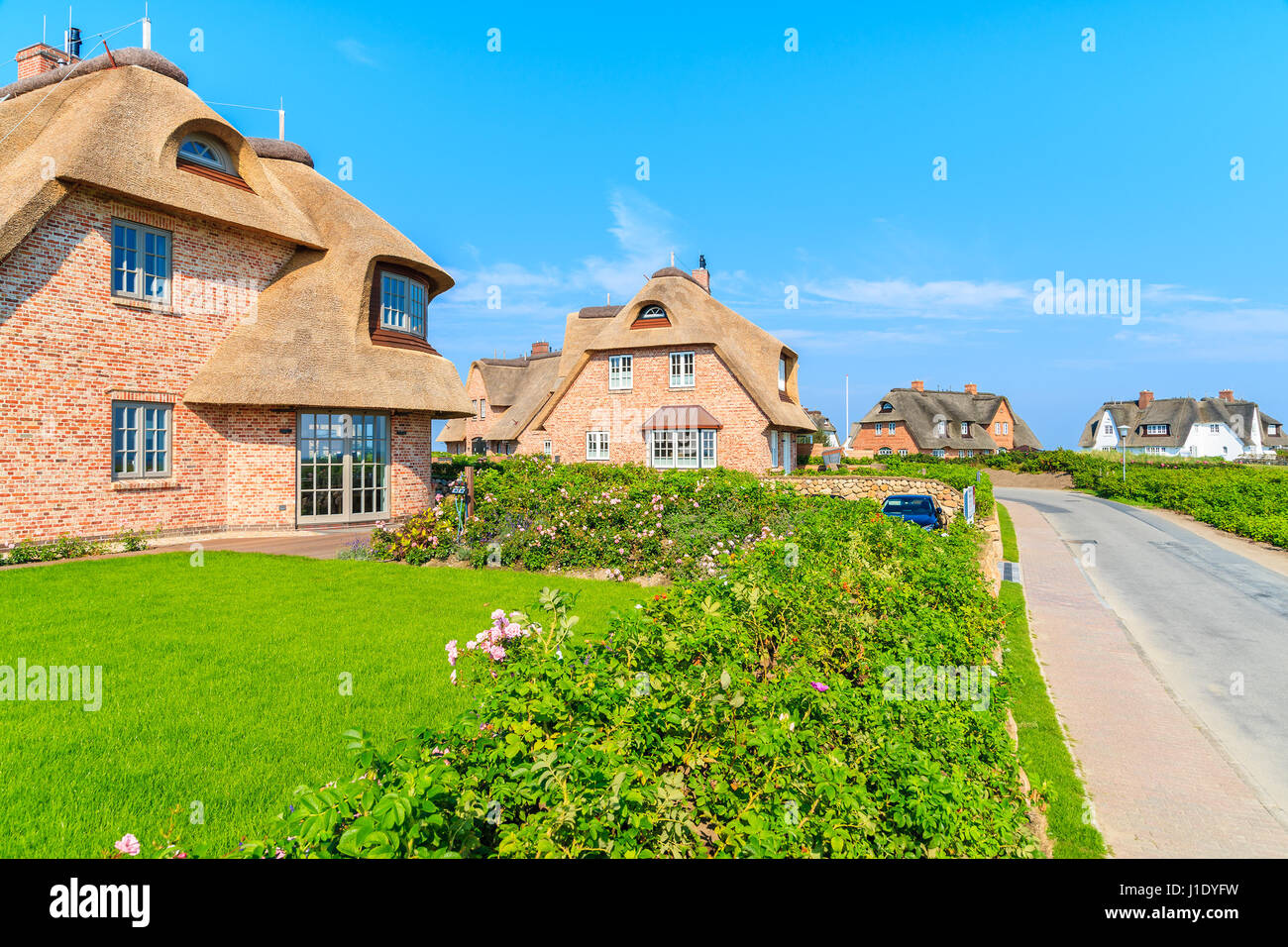 Typical Frisian red brick houses with straw roofs in Rantum village on southern coast of Sylt island, Germany Stock Photo