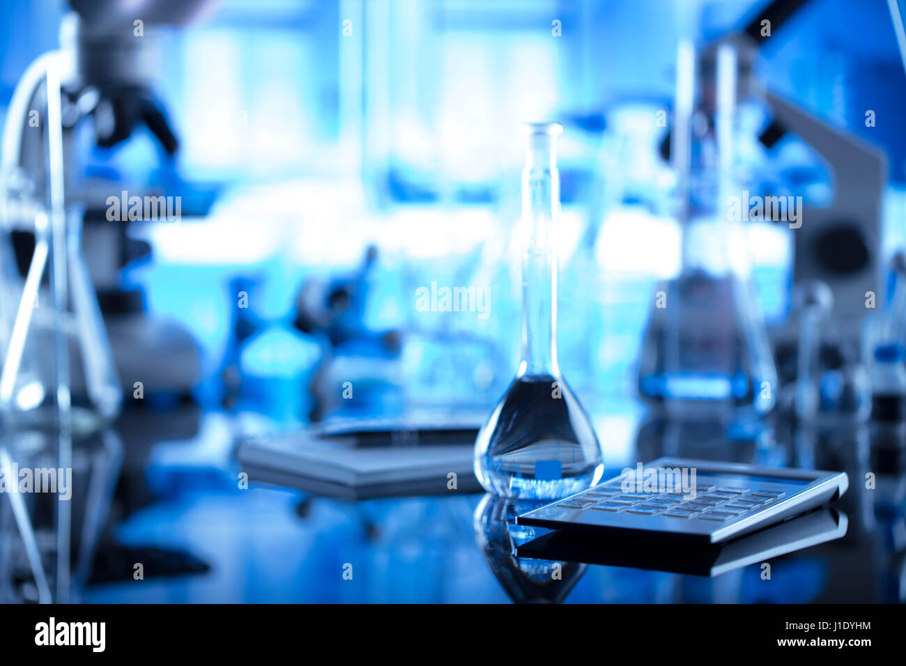 Modern laboratory equipment , set of different glassware on blue ...