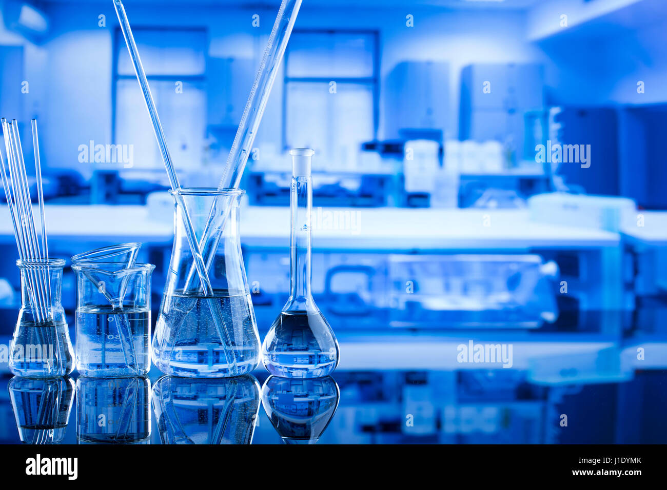 Modern laboratory equipment , set of different glassware on blue ...