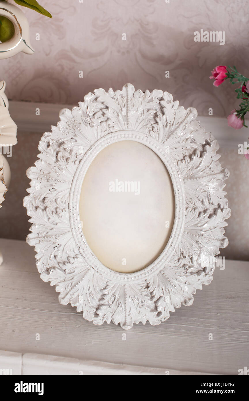 Vintage wooden white frame for photo on the table Stock Photo