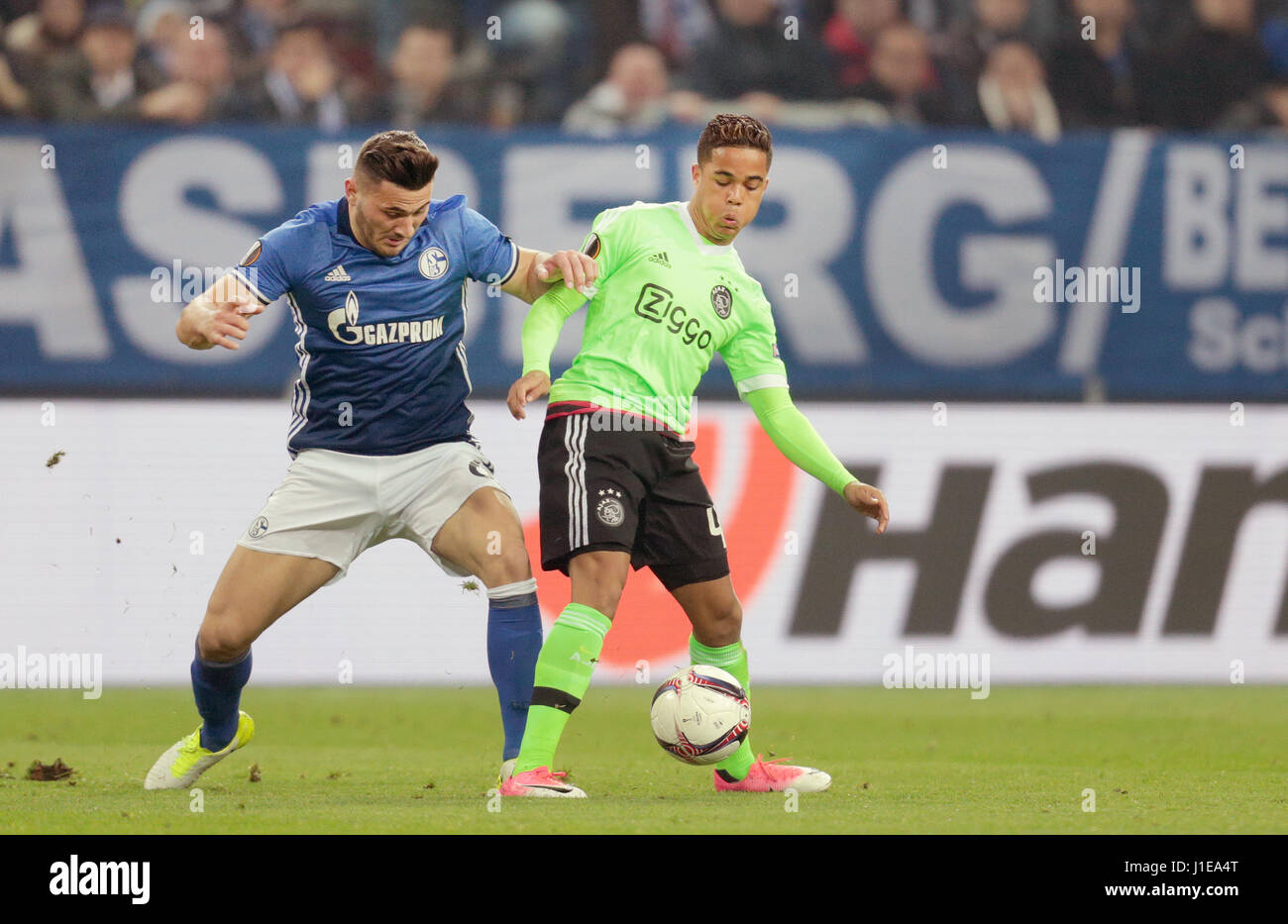 Gelsenkirchen, Germany. 20th Apr, 2017. Schalke's Sead Kolasinac vand Ajax's Justin Kluivert (r) vie for the ball during the second leg of the UEFA Europa League quarter final tie between FC Schalke 04 and AFC Ajax in the Veltins Arena in Gelsenkirchen, Germany, 20 April 2017. The game finished 3:2 and 3:4 on aggregate. Photo: Ina Fassbender/dpa/Alamy Live News Stock Photo