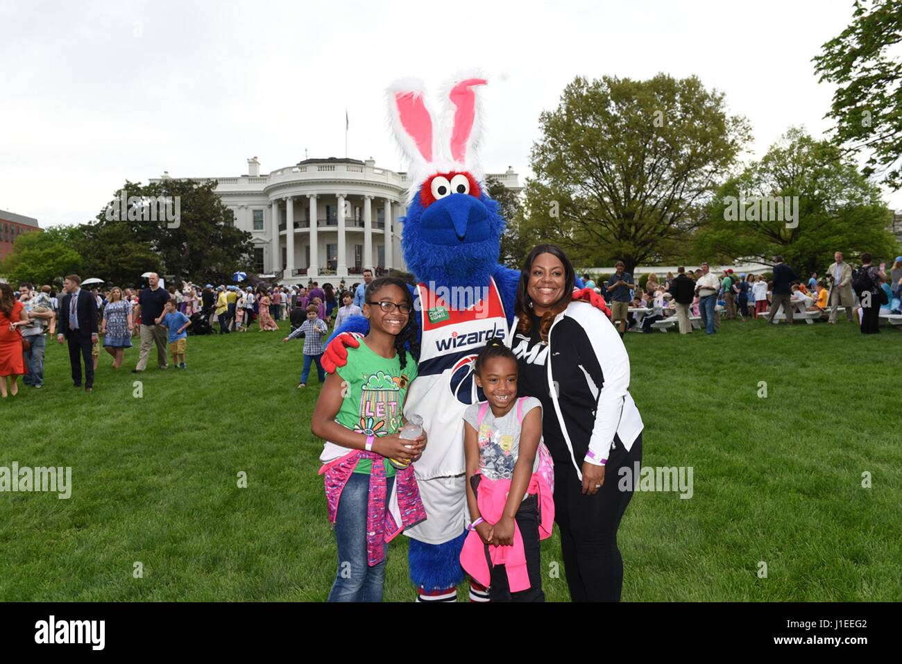 A family poses with the Washington Wizards mascot, G-Wiz, wearing bunny ears during the annual Easter Egg Roll on from the South Lawn of the White House April 17, 2017 in Washington, D.C. Stock Photo